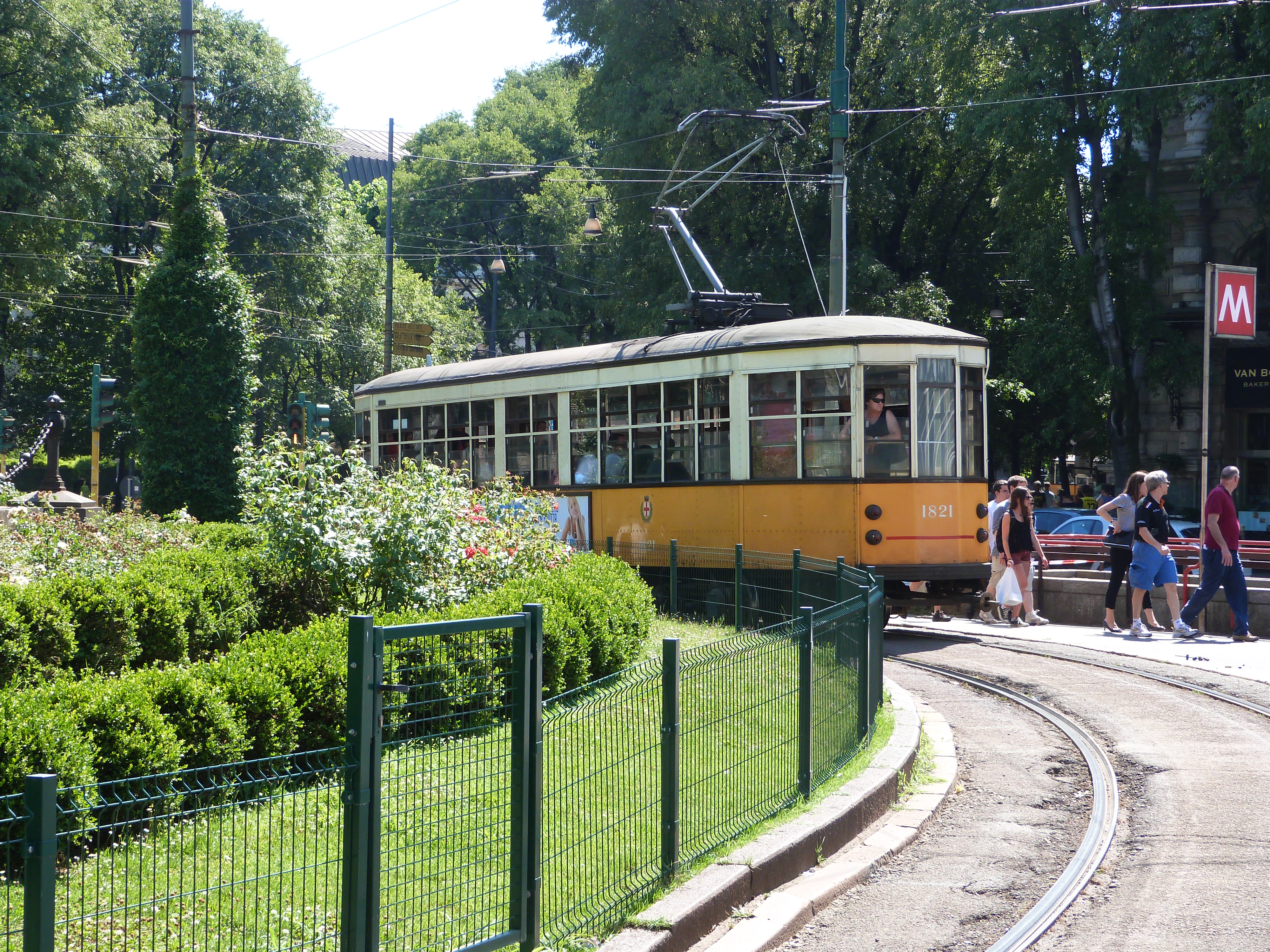 A tram lurking behind a nicely kept floral display